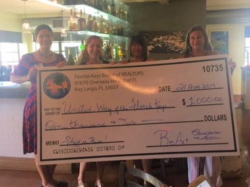 The Florida Keys Board of Realtors gives a very generous donation for school children to CEO Leah Stockton and Board Member Jana Caylor